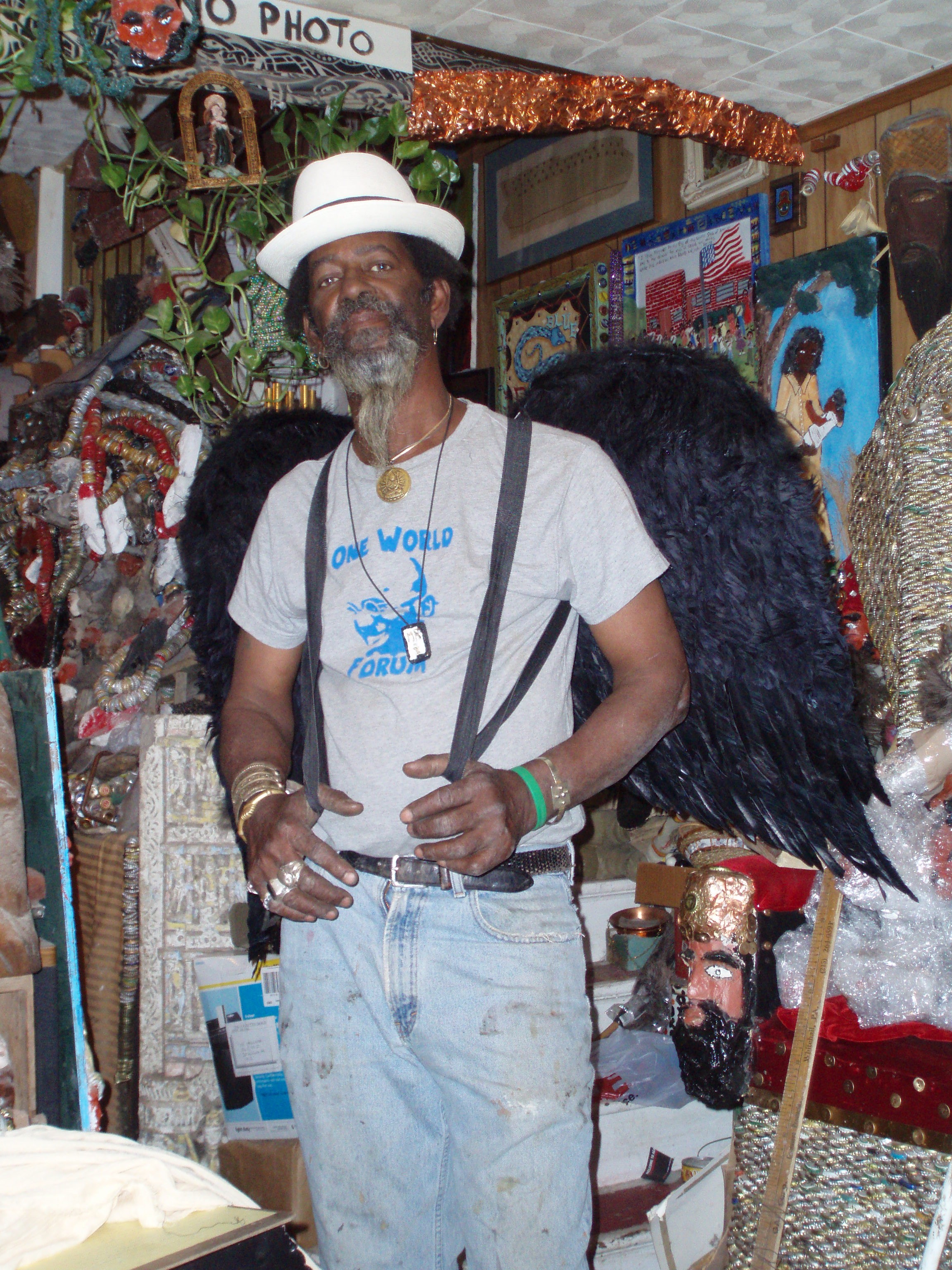 The artist known as Mr. Imagination poses wearing black feathery angel wings