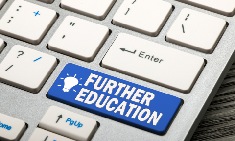 Computer keyboard with a highlighted key that says "Further Education"