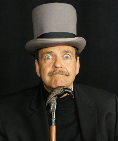 Actor in grey top hat holding a cane with a raven handle